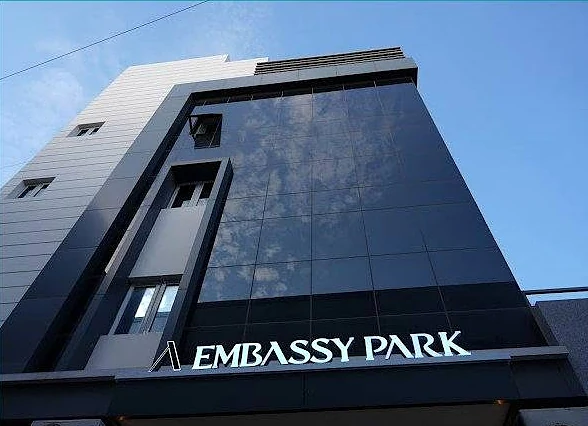 The Embassy Park sign by day