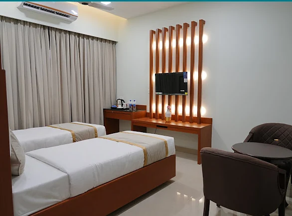 Twin room with slatted wooden TV wall