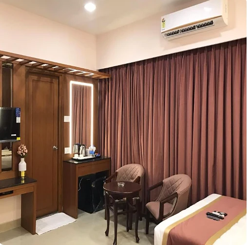 Twin room with maroon curtains